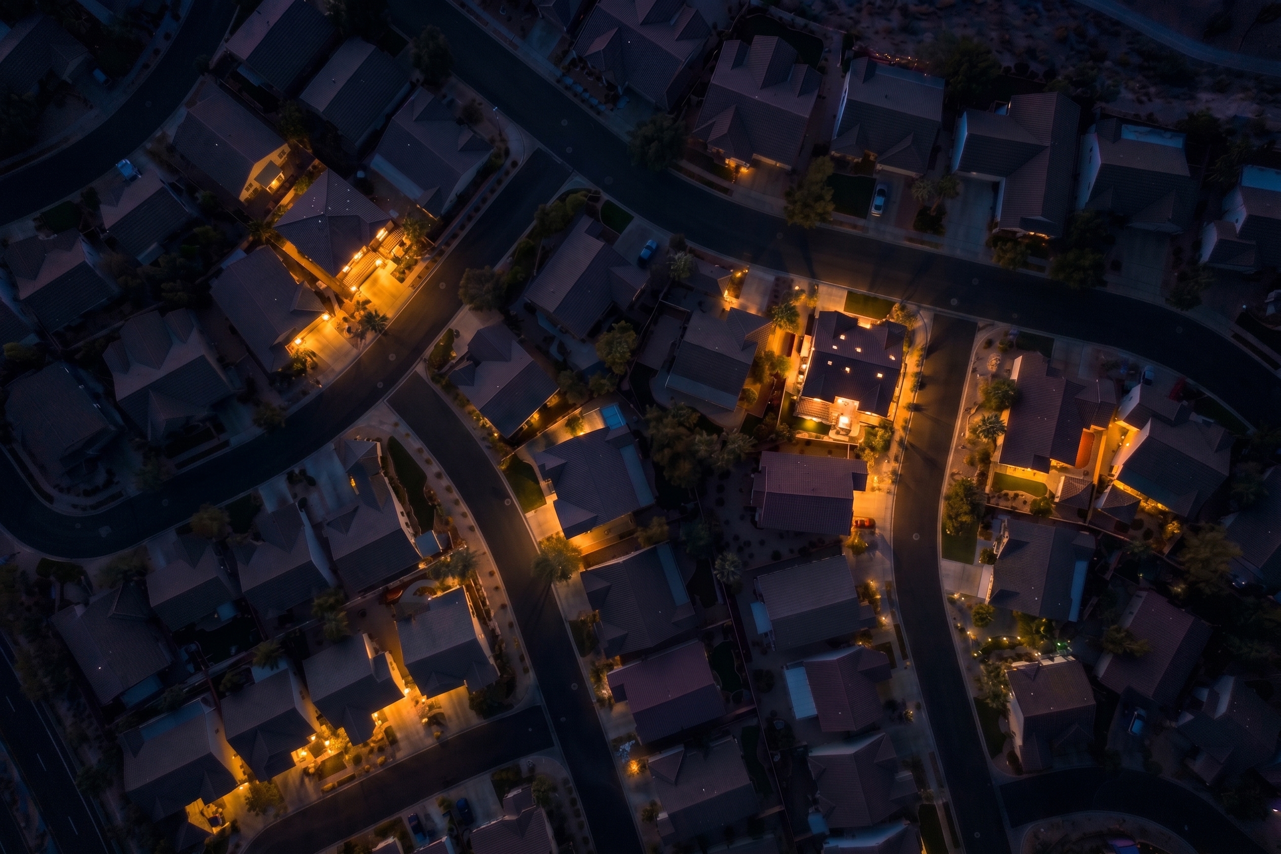 Residential neighbourhood with homes illuminated at night